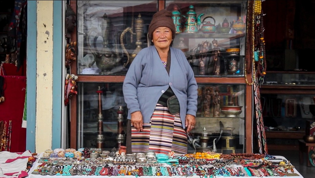 A Tibetan woman sells jewelry and handcrafts in the Tashiling Tibetan settlement. (Photo: Victoria Nechodomu)